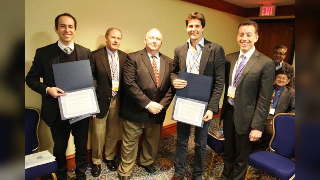 Marcello Montanino and Vincenzo Punzo holding award certificates with members of the TRB committee