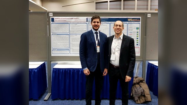 Marcello Montanino and Vincenzo Punzo standing in front of their poster on uncertainty and stochasticity in traffic simulation