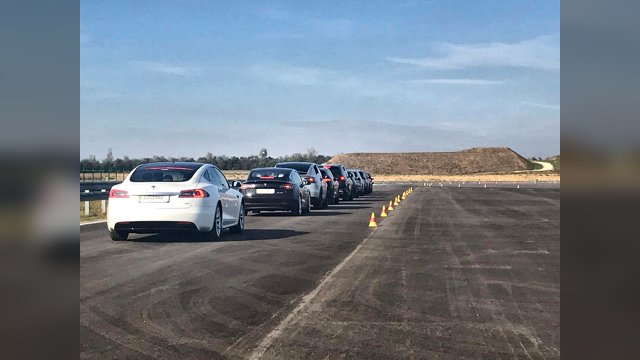 A queue of production cars equipped with adaptive cruise control lined up on the ZalaZONE test track