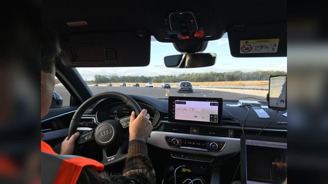 View from the rear seat of an instrumented Audi during the ZalaZONE OpenACC tests, with laptops and sensors visible