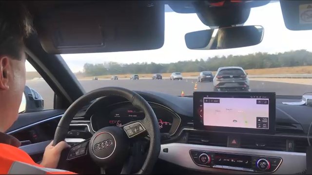 A convoy of adaptive-cruise-control-equipped production cars driving during the ZalaZONE string-stability experiment
