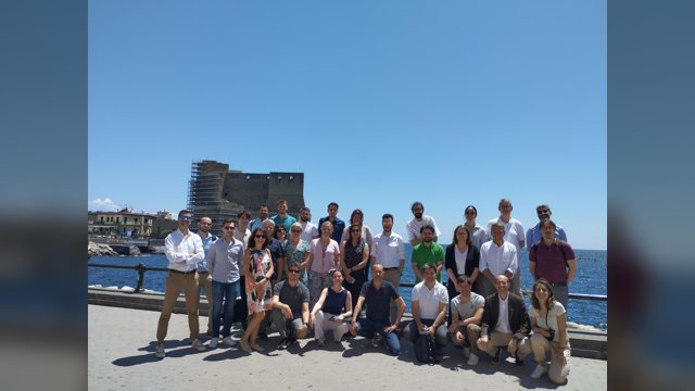 ACUMEN consortium members posing by the sea in Naples with Castel dell'Ovo in the background