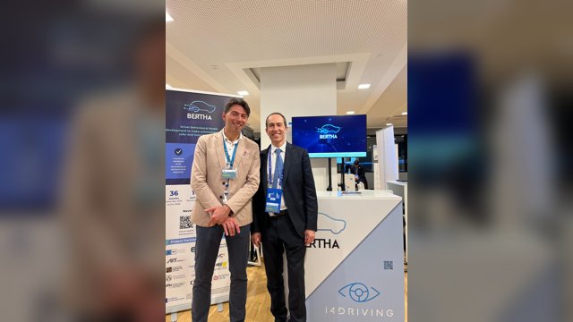 Vincenzo Punzo and Biagio Ciuffo of the European Commission's Joint Research Centre standing between the i4Driving and BERTHA displays at EUCAD 2025