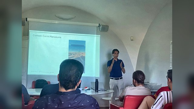 Giovanni Albano presenting a slide titled Context: Cut-in Manoeuvre to summer-school participants
