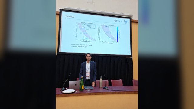 Giovanni Albano standing below a projected slide with graphs of motorway cut-in scenarios at the IEEE ITSC 2026 workshop