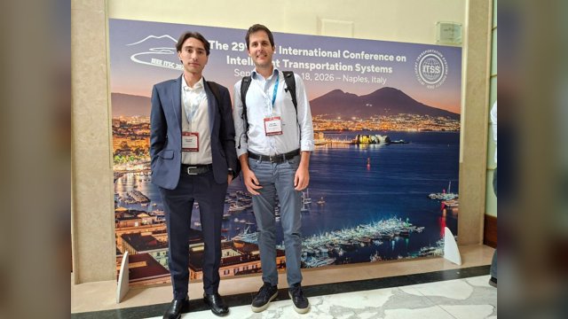 Giovanni Albano, left, and Marcello Montanino, right, standing in front of the IEEE ITSC 2026 conference backdrop