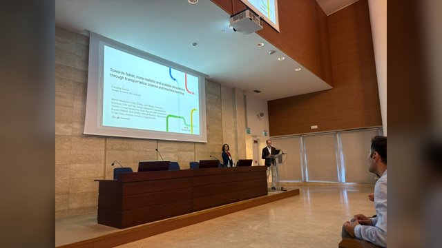 Vincenzo Punzo introducing Carolina Osorio beside a projected title slide during a keynote session at MFTS 2026